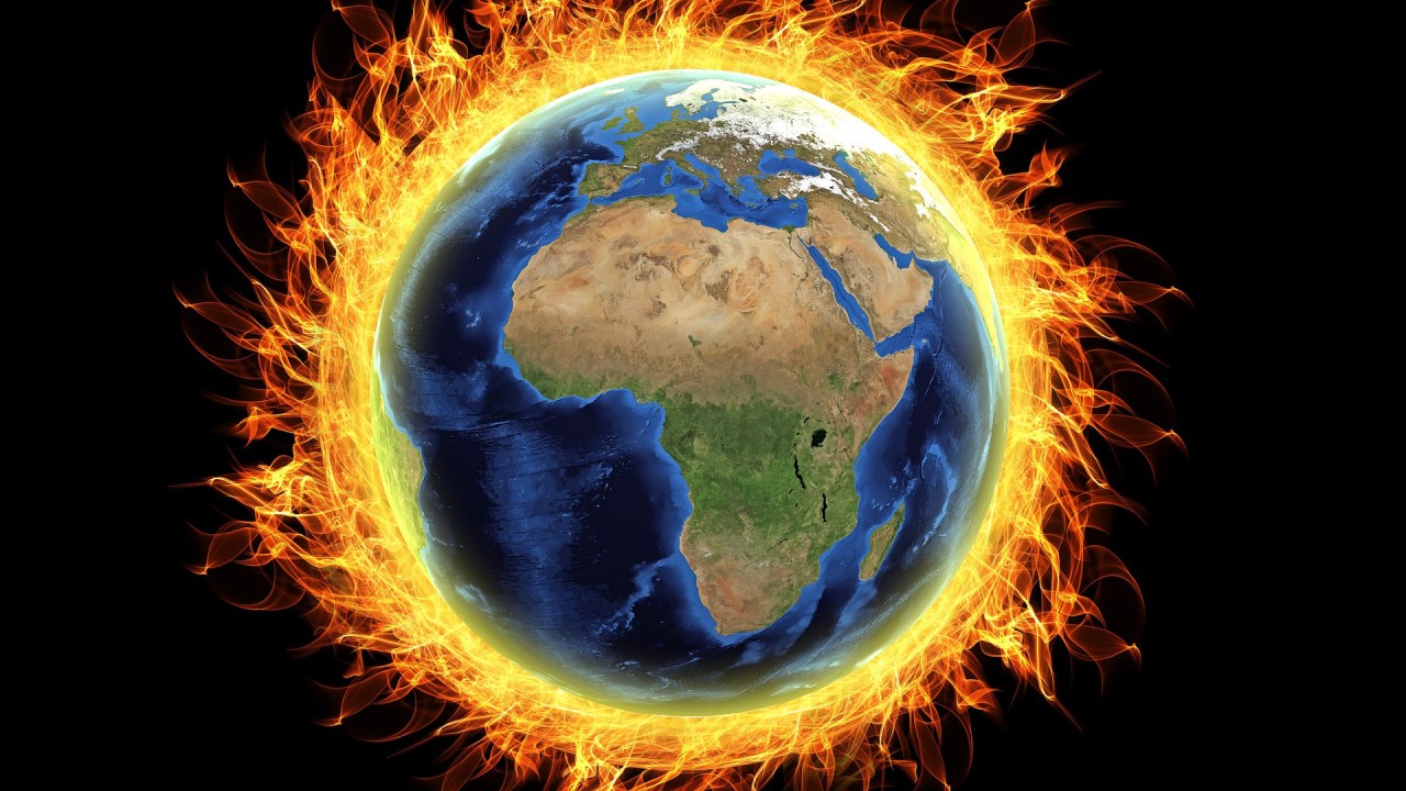 A imagem mostra o globo terrestre circundado por fogo, representando a mensagem do aquecimento global