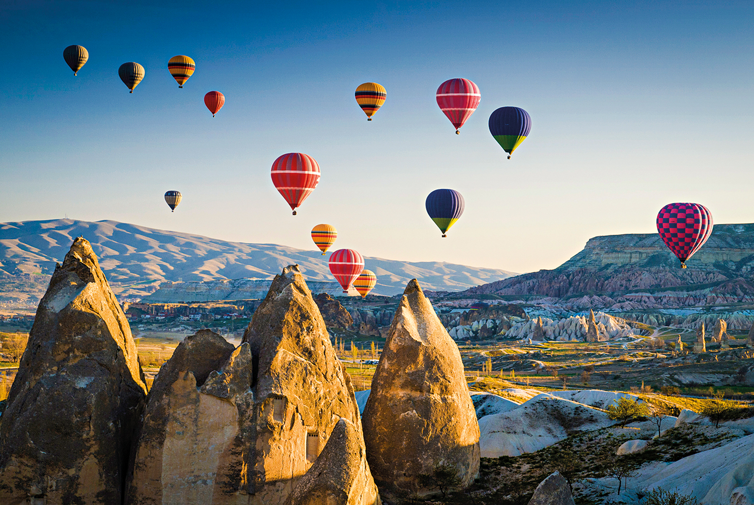 Hot air balloons at sunrise flying over Cappadocia, Goreme, Turkey